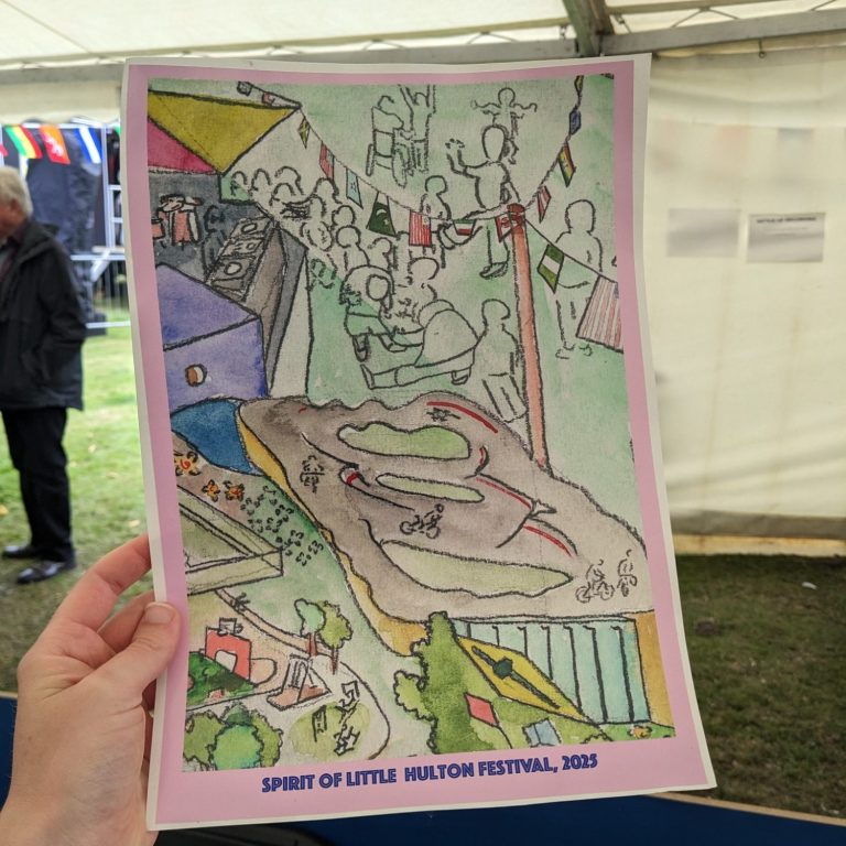 Community Art Group Photo of a pile of artwork, including a drawing of a rubix cube, colourful cut-out geometric shapes, and paperchain made of the same shapes